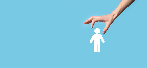 Fototapeta premium Male hand holding human icon on blue background. Human Resources HR management Recruitment Employment Headhunting Concept.Select team leader concept. Male hand click on man icon.Banner ,copy spase.