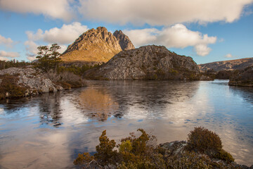 Beautiful ,evening ,light ,over one of the Twisted Lakes. Cradle Mountain in the distance. Cradle Mountain Lake St Clair National Park. Central Highlands of Tasmania, Australia.