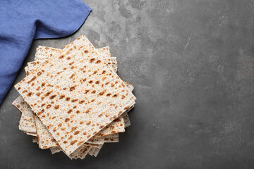 Stack of matzos on grey table, flat lay. Space for text