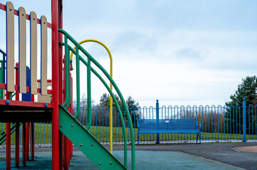 Public colouful modern playground in the park in gloomy day spring, Outdoor playground equipment for children