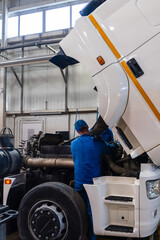 Mechanic repairing the truck in the garage	
