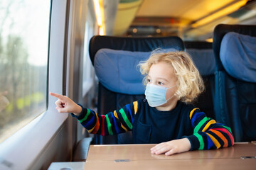 Kids travel by train in face mask. Virus outbreak.