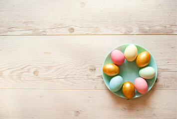painted easter eggs lie on a blue plate