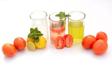 the healthy food tomato ,lemon,mint,juice with tomato ,lemon,and mint plant isolated on white background.