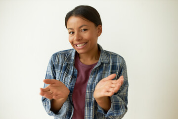 I am not sure. Isolated image of beautiful casually dressed young black female smiling shyly feeling confused because of awkward situation gesturing helplessly. Perplexed girl expressing confusion