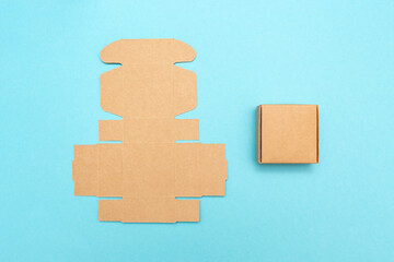 Self-gathering cardboard box. Delivery, moving, gift wrapping on a colored background. Blank...