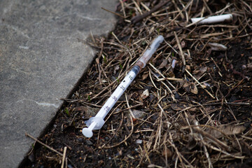 Used syringe lying on the street, drugs 