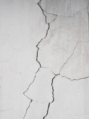 Cracks on the white wall.