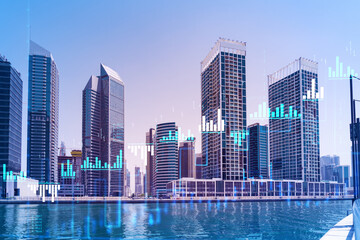 Fototapeta na wymiar Skyscrapers of Dubai business downtown. International hub of trading and financial services of Western Asia. FOREX graph and chart concept. Double exposure. Dubai Canal waterfront.