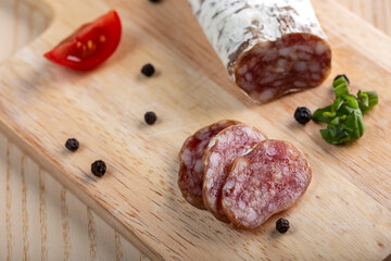 Homemade Italian salami on wooden cutting board