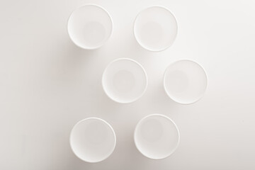 disposable picnic tableware. foam polystyrene disposable cups on white background with copy space...