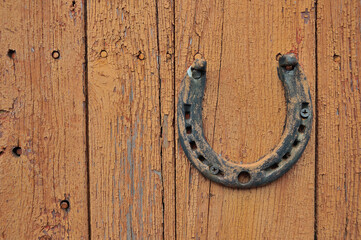 old horseshoe on wooden wall