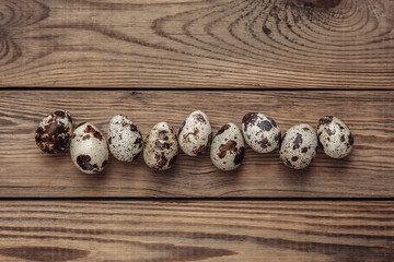 Quail eggs on wooden table. Easter concept. Top view