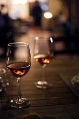 Close up on Glass of Red Wine with Lights Background.