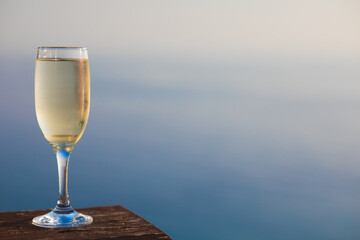 glass of prosecco over the sea background