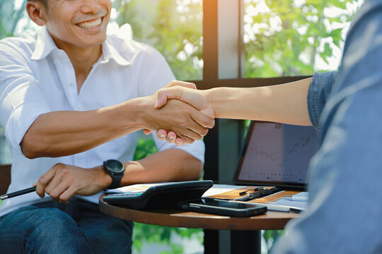 Businessmen shaking hands together happy. After the negotiations were successful