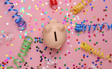 Piggy bank with Colored streamer and confetti on a pink background. Save money. Holiday, birthday costs