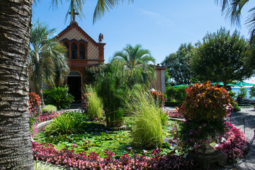 a flowery pond surrounded by palatial architecture and a temple on the shore of Odin and the Borromean Islands on Lake Maggiore