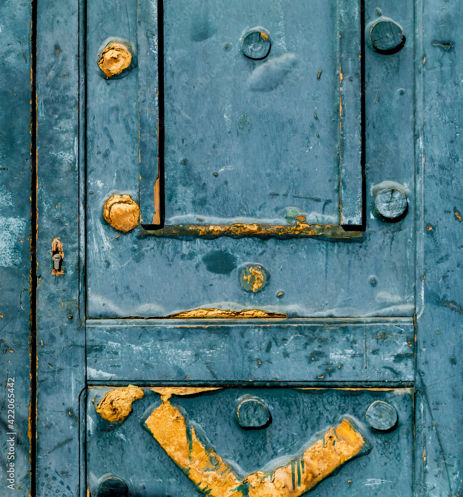 Wall mural Fragment of old door with cracked paint