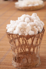 White natural cotton wool in bamboo basket. Selective focus
Thai and asian culture concept.