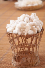 White natural cotton wool in bamboo basket. Selective focus
Thai and asian culture concept.