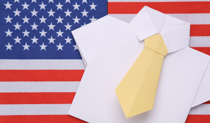 Origami shirt with tie on the background of the USA flag. Politics or business concept