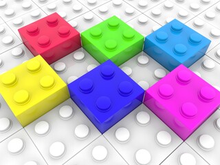 Colored toy bricks on white toy bricks