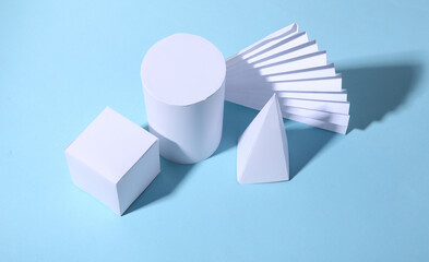 Basic geometric shapes against blue bright background with shadow. Minimalism