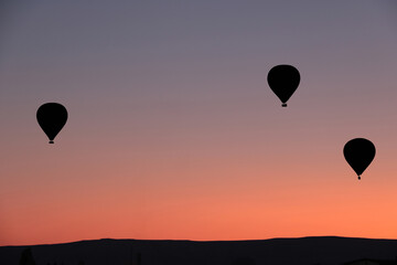 silhouette of hot air balloons against amazing sky