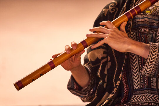 Close-up of a street musician playing Bansuri Indian Flute