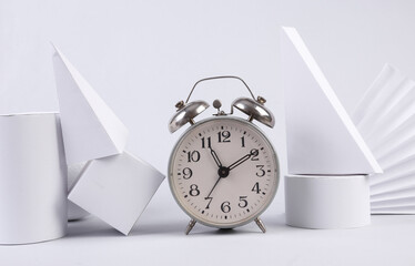 Alarm clock and geometric shapes on white background. Concept art. Minimalism
