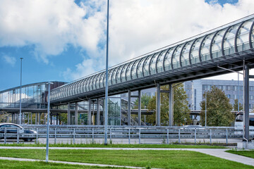 A glass tunnel above a road leading to the airport.