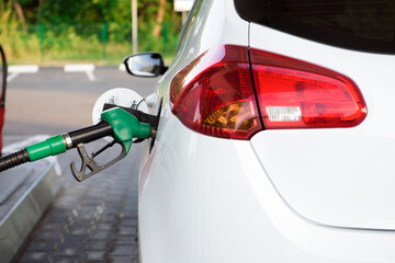 The driver pump the car's gasoline with fuel at the petrol station. Car refueling at a gas station.