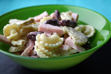 Salad of pasta, ham, beans and pickled cucumbers. Belgian cuisine.