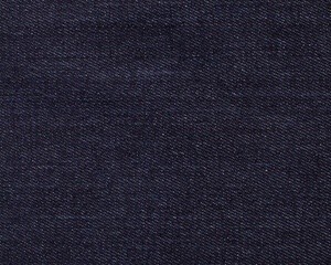 Dark blue denim with a close-up of white splashes. Background, texture, abstraction.copy space