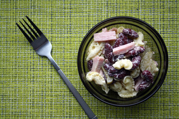 Salad of pasta, ham, beans and pickled cucumbers. Belgian cuisine.