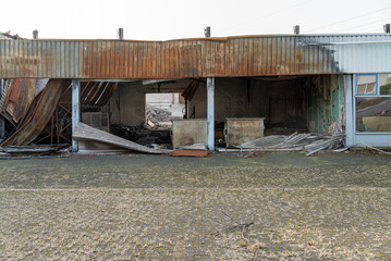 Burned down warehouse with rusted roof
