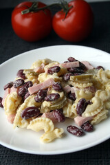 Salad of pasta, ham, beans and pickled cucumbers. Belgian cuisine.