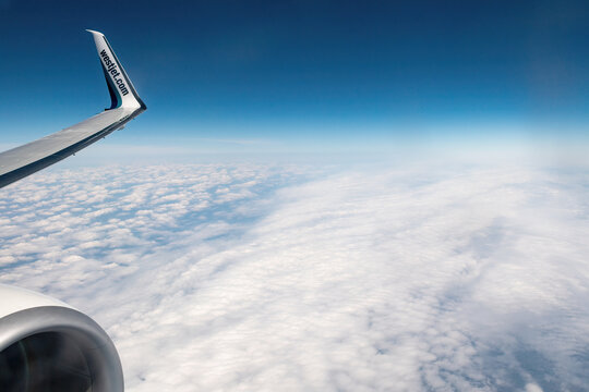 Winglet Of A Westjet Branded Plane Flying Over Beautiful Clouds