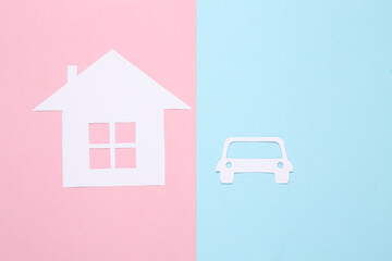 Paper-cut house and car on a blue-pink background. Property