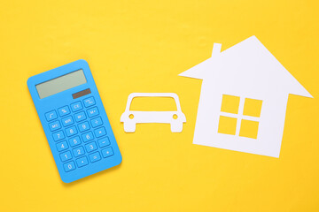 Calculator, Paper-cut house and car on yellow background. Property insurance