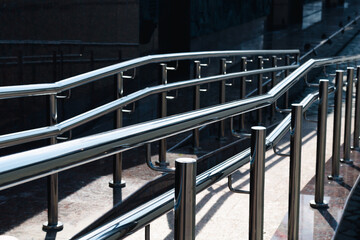 Irregular chrome ramp railing with bright highlights
