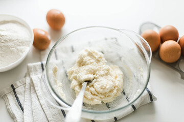 Cooking raw ingredients on white table, making cake.