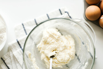 Cooking raw ingredients on white table, making cake.