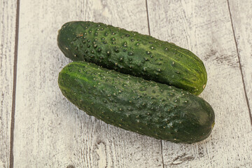 Green fresh cucumbers over background