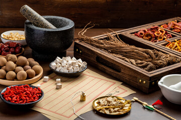 Ancient Chinese medicine books and herbs on the table