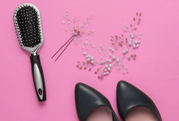 Fees of the bride, wedding day. Decoration in the hair of the bride, comb, high heel shoes on pink background