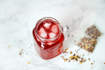 Pink drink with bissap juice, hibiscus and ice for herbal tea or iced tea 