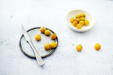 Plum with knife and plate from top view