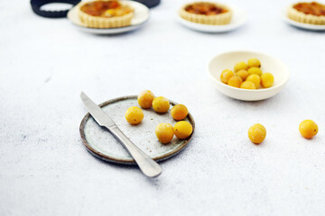 Plum with knife and plate from top view